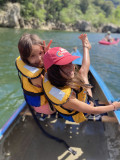 Jeunes filles heureuses dans le canoë du moniteur